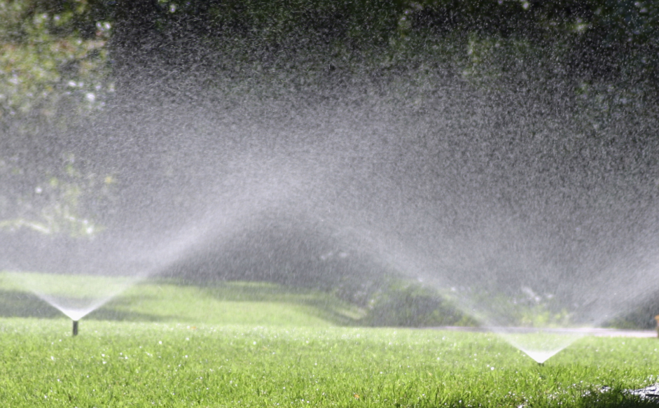 Automatic sprinklers running on a lawn