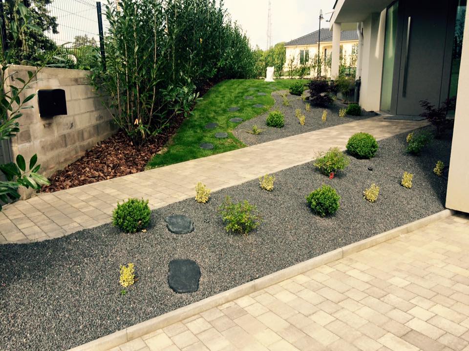 Landscaped garden with mineral beds and plantings along a terrace