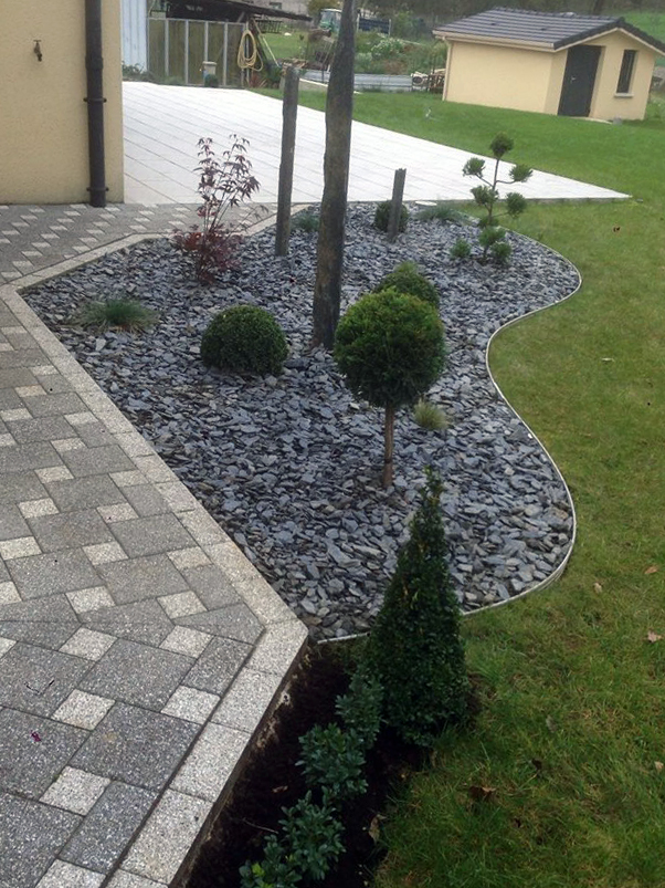 Mineral landscaping with shrubs clipped into balls
