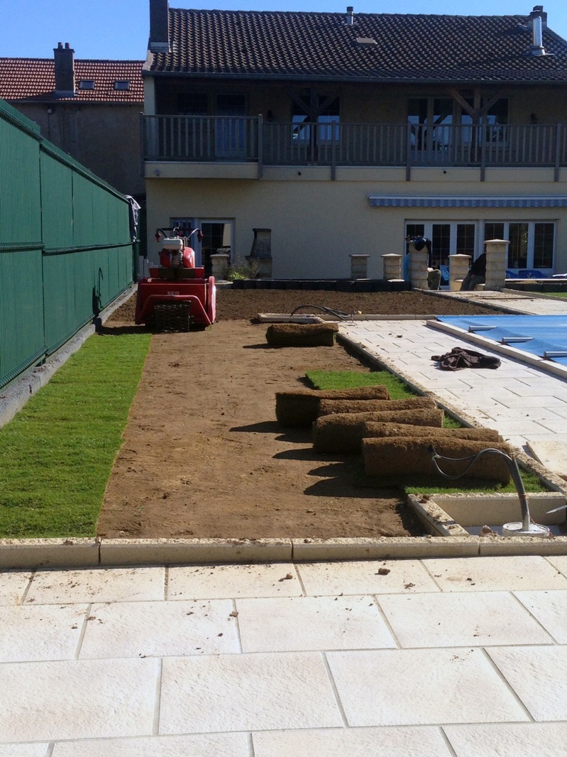 Laying roll-out turf in a villa garden